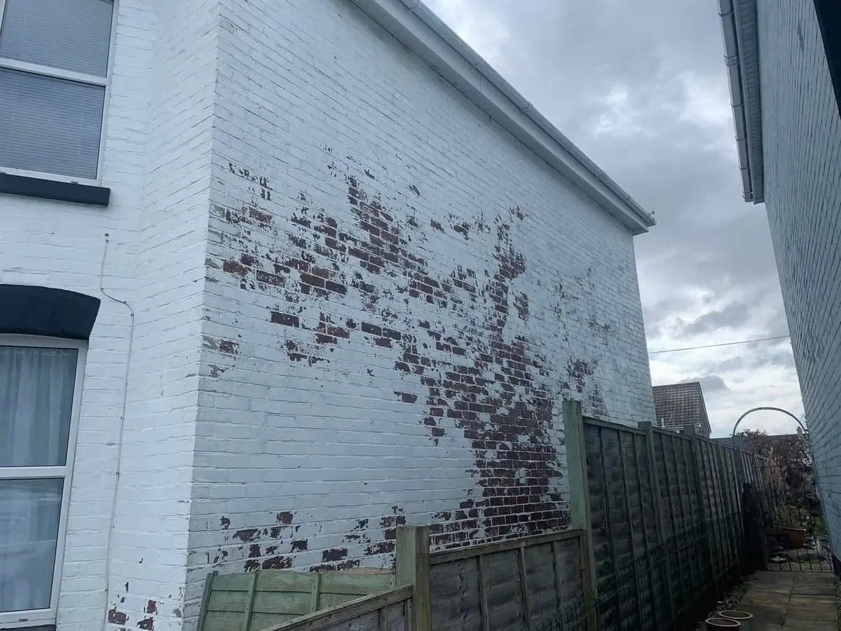 Peeling paint on a brick wall before redecoration in Ivybridge