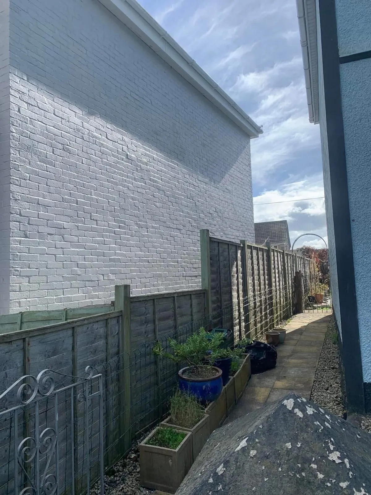 Freshly painted brick wall after preparation and masonry paint in Ivybridge